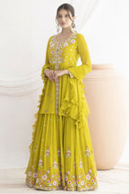 Woman wearing a yellow embroidered haldi traditional outfit on a white background