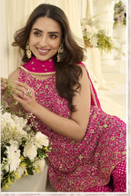 Close-up view of a reddish pink pakistani gharara suit in georgette with Swarovski, Zarkan and embroidery work on the kameez.