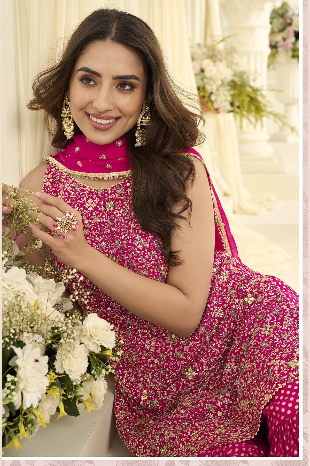 Close-up view of a reddish pink pakistani gharara suit in georgette with Swarovski, Zarkan and embroidery work on the kameez.