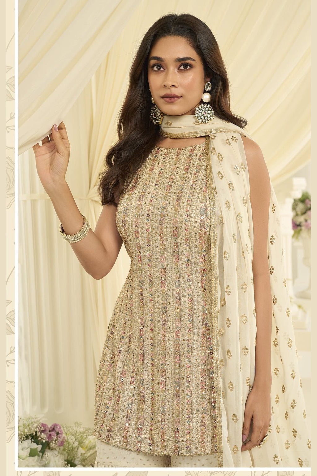 Close-up view of a cream gharara suit in georgette with Swarovski, Zarkan and embroidery work on the kameez neckline and bodice.