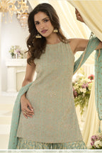 Close-up view of a mint green gharara suit in georgette with Swarovski, Zarkan and embroidery work on the kameez neckline and bodice.