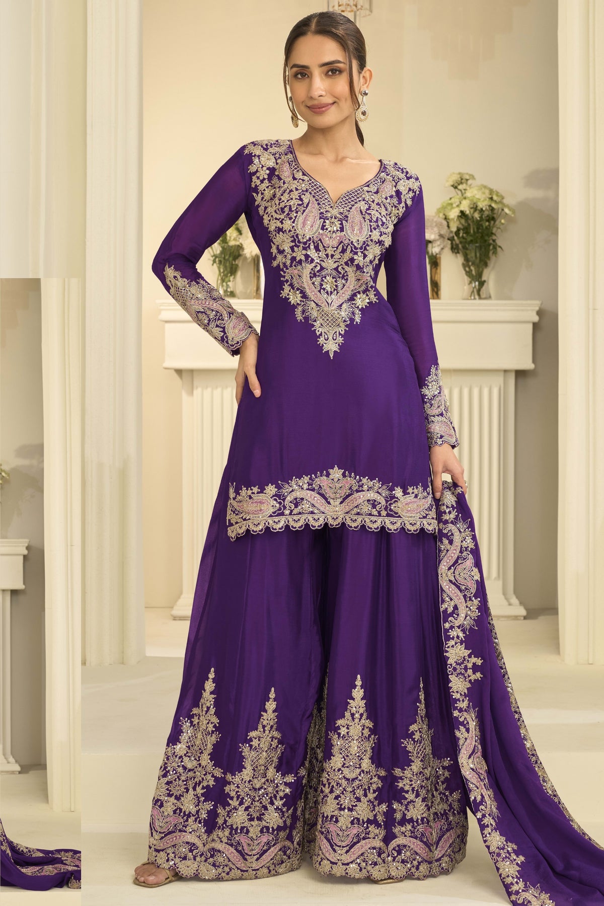 Woman wearing purple indian wedding guest dresses style plazo suit in chinon silk with thread and sequin embroidery, embroidered plazo and dupatta, full-length front view.