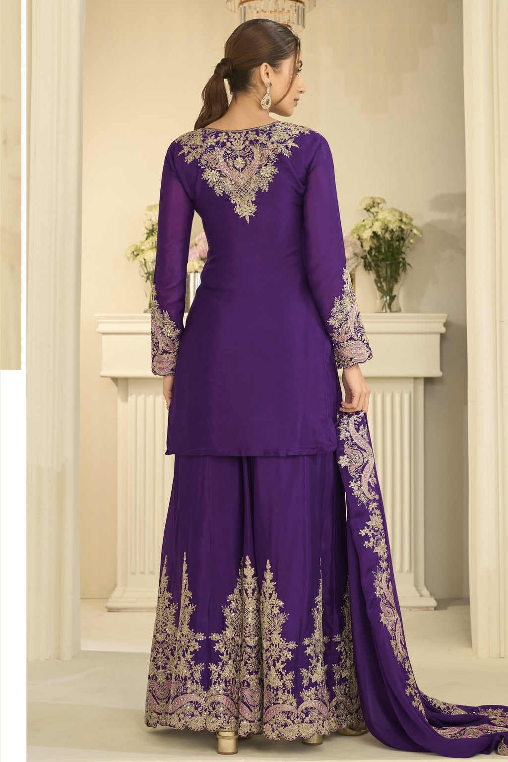 Full-length back view of a purple indian wedding guest dresses style plazo suit in chinon silk with thread and sequin embroidery on the back and dupatta.