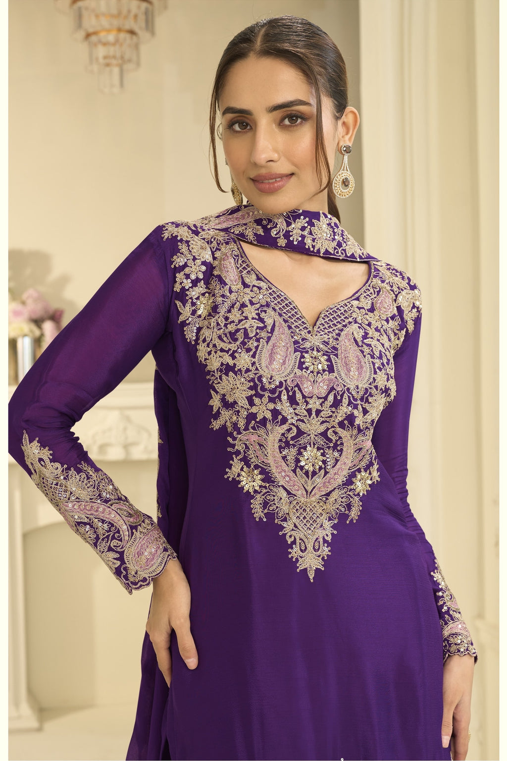 Close-up of a purple palazzo suit bodice in chinon silk with delicate thread and sequin embroidery on the neckline and sleeves.