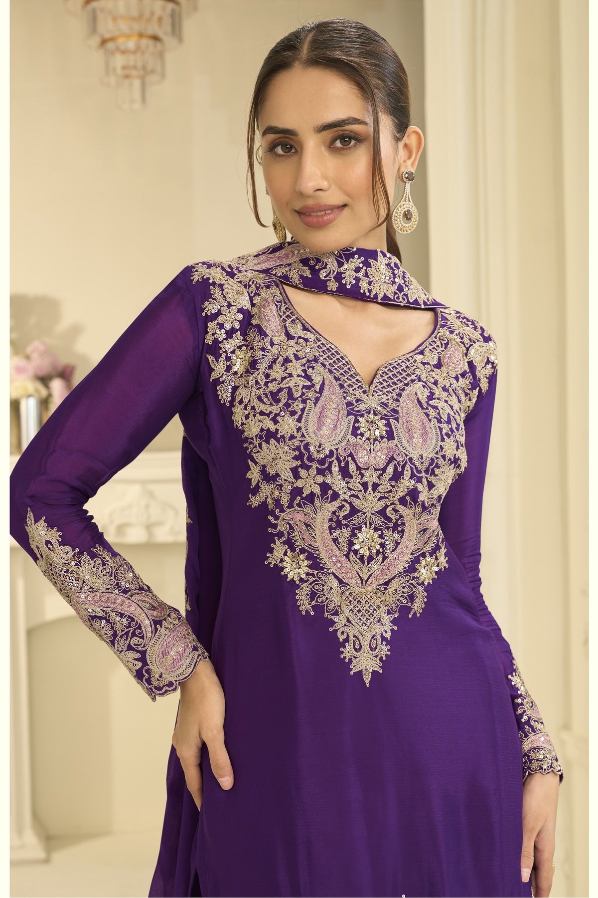 Close-up of a purple palazzo suit bodice in chinon silk with delicate thread and sequin embroidery on the neckline and sleeves.