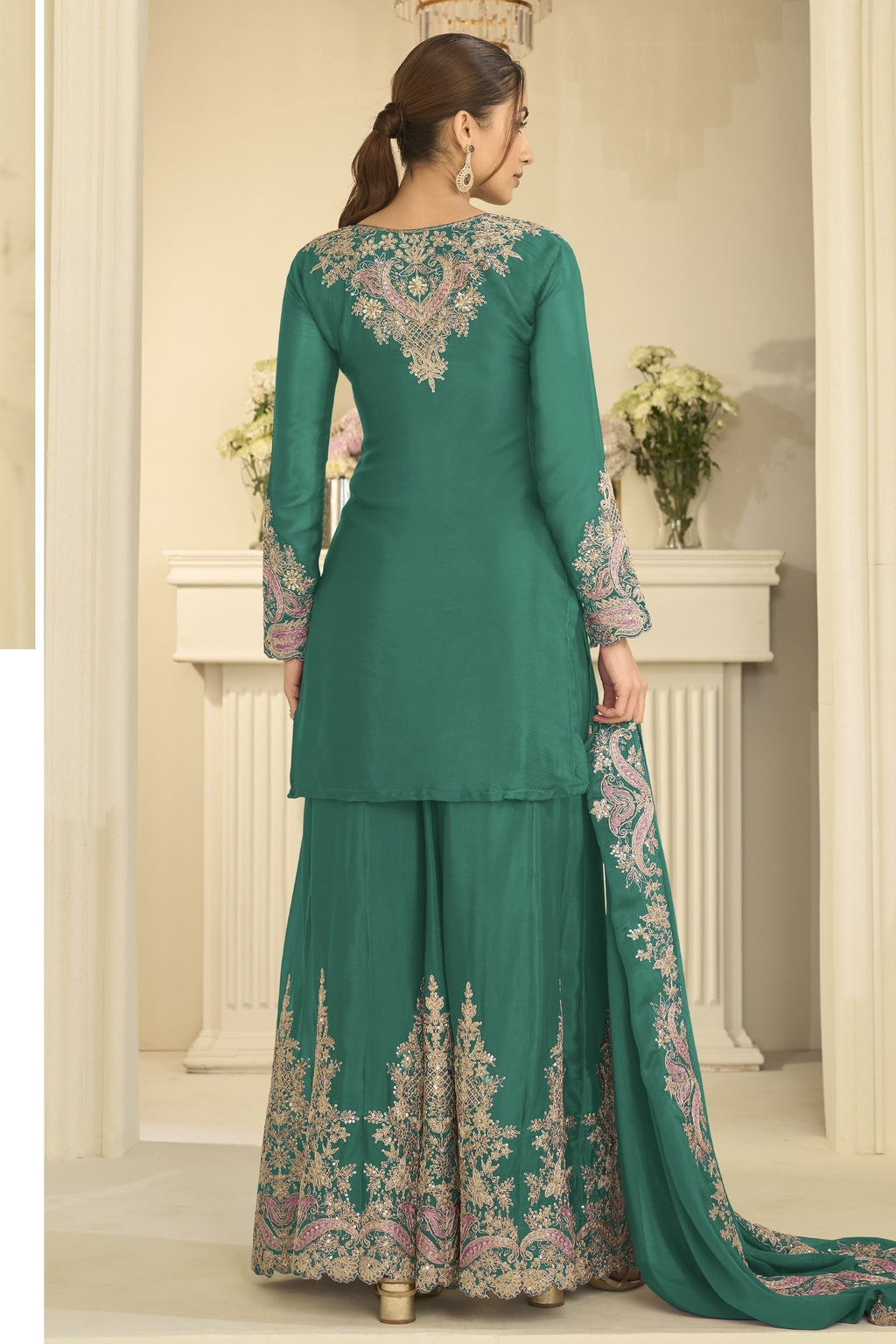 Full-length back view of a teal palazzo suit in chinon silk with delicate thread and sequin embroidery on the back and dupatta.