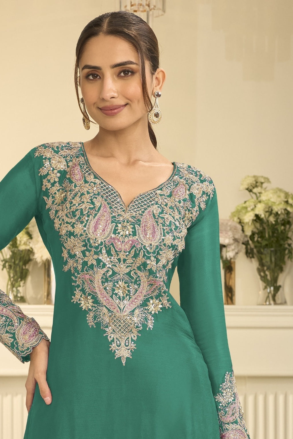 Torso detail view of a teal indian wedding guest dresses style plazo suit in chinon silk with thread and sequin embroidery on the kameez.