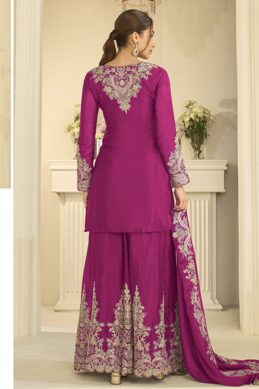 Full-length back view of a magenta festive wear for women style plazo suit in chinon silk with thread and sequin embroidery on the back and dupatta.