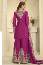 Full-length back view of a magenta festive wear for women style plazo suit in chinon silk with thread and sequin embroidery on the back and dupatta.