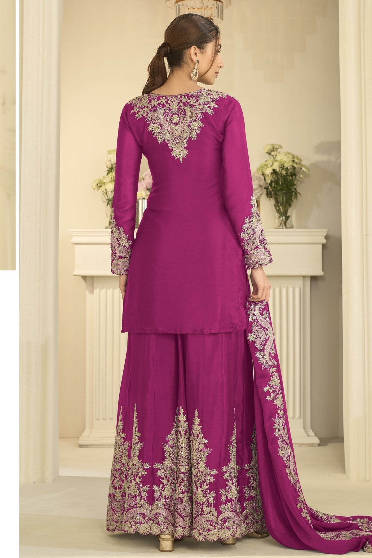 Full-length back view of a magenta festive wear for women style plazo suit in chinon silk with thread and sequin embroidery on the back and dupatta.