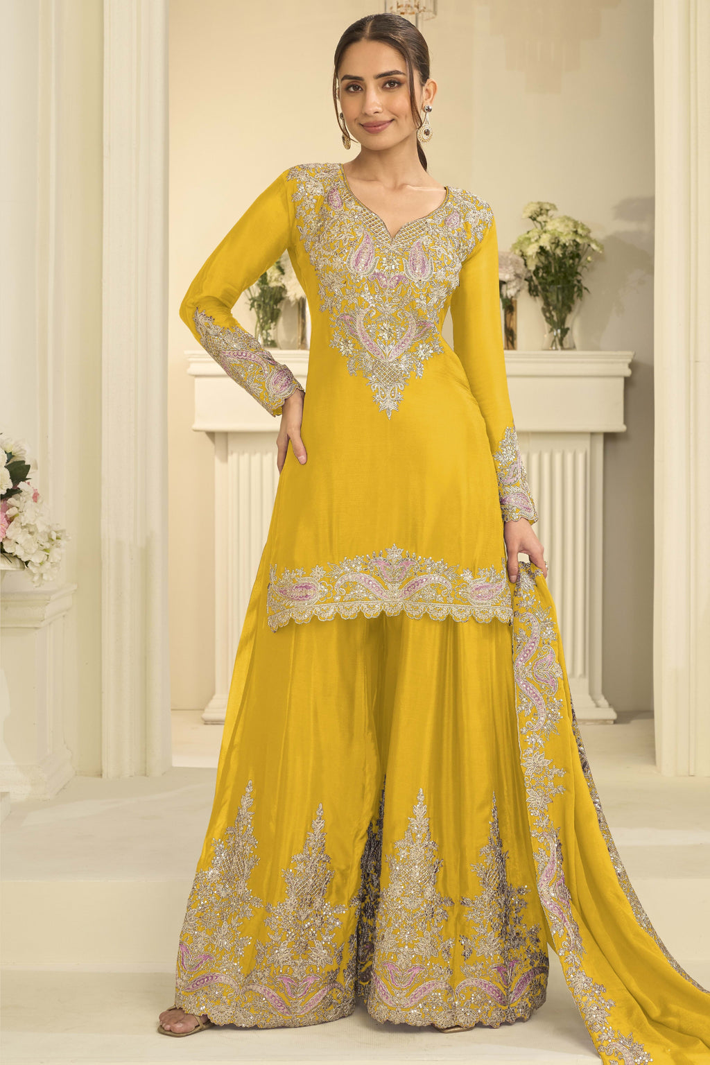 Woman wearing a yellow palazzo dress in chinon silk with thread and sequin embroidery, embroidered plazo and dupatta, full-length front view.
