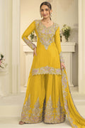 Woman wearing a yellow palazzo dress in chinon silk with thread and sequin embroidery, embroidered plazo and dupatta, full-length front view.