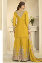 Full-length back view of a yellow palazzo dress in chinon silk with thread and sequin embroidery on the back and dupatta.