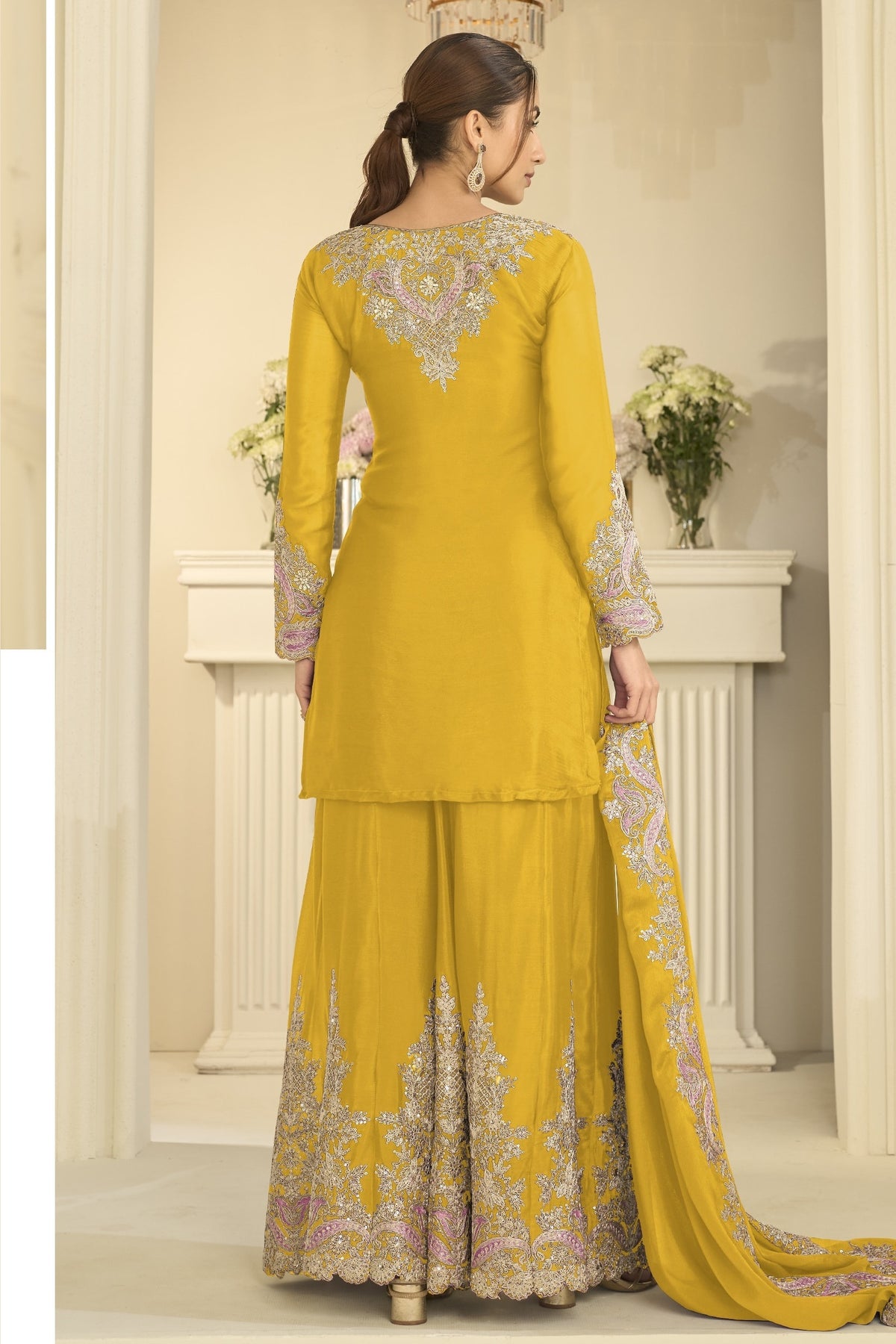 Full-length back view of a yellow palazzo dress in chinon silk with thread and sequin embroidery on the back and dupatta.