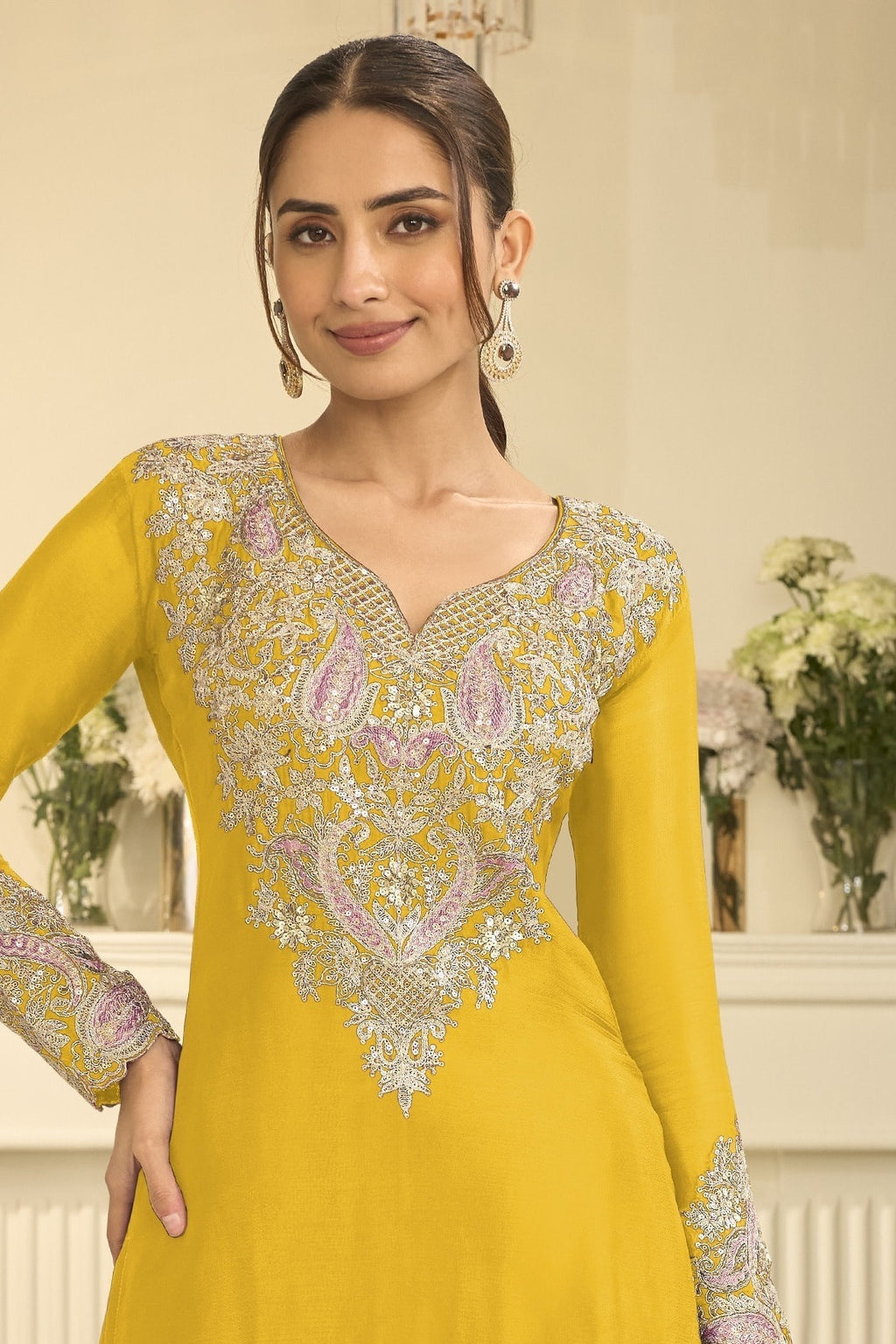 Torso detail view of a yellow indian party wear outfits style plazo suit in chinon silk with thread and sequin embroidery on the kameez.