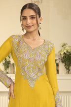 Torso detail view of a yellow indian party wear outfits style plazo suit in chinon silk with thread and sequin embroidery on the kameez.