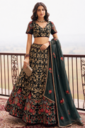 Woman wearing a dark green wedding reception lehenga with embroidery work, short sleeve V neck net choli, full-length front view.