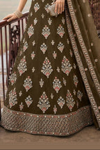 Lower view of a brown georgette lehenga for women with embroidered net lehenga skirt and matching dupatta drape. All-over embroidery.