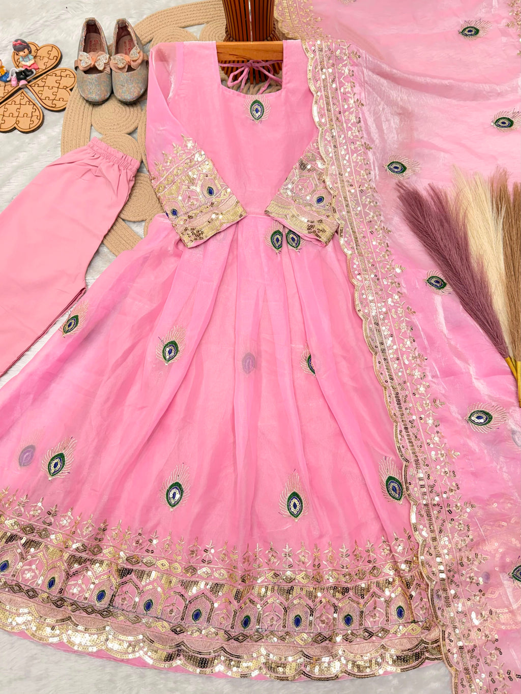Light pink ethnic kidswear girls anarkali set flat lay with cotton pant and embroidered fendy silk dupatta, full set view.