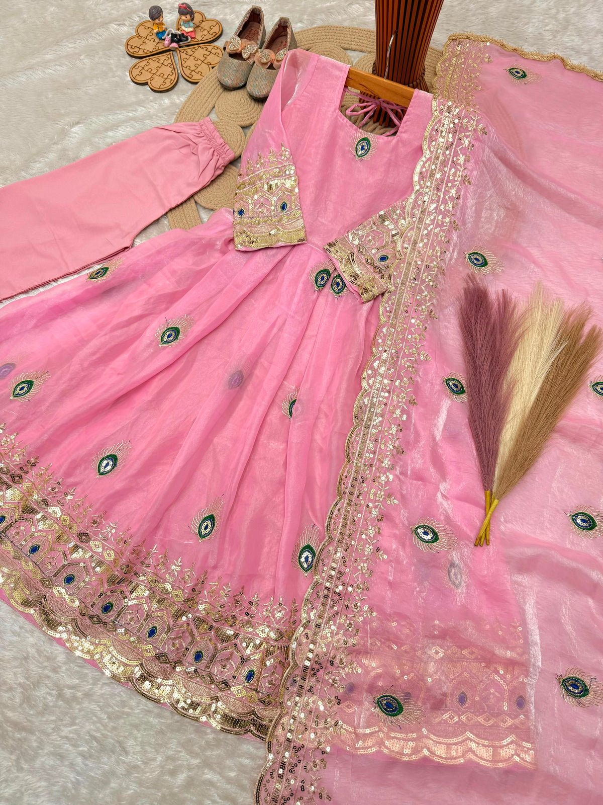 Light pink indian kidswear girls anarkali set flat lay showing the full three-piece set with embroidered dupatta.