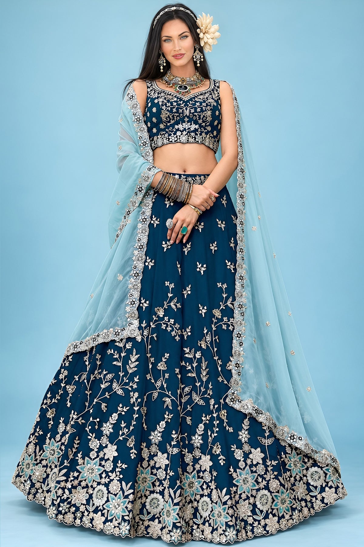 A navy blue lehenga for wedding guest with a sleeveless sweetheart blouse, flared rangoli silk skirt and matching dupatta, shown in a full front view.