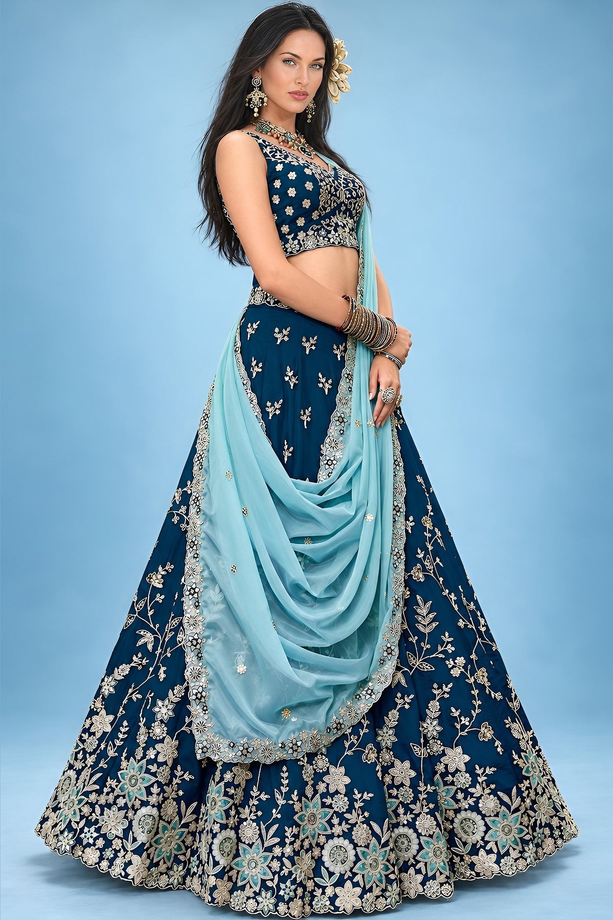 This navy blue lehengas for wedding guest outfit pairs a sweetheart neckline blouse with a flared skirt detailed in zari, sequin and thread work.