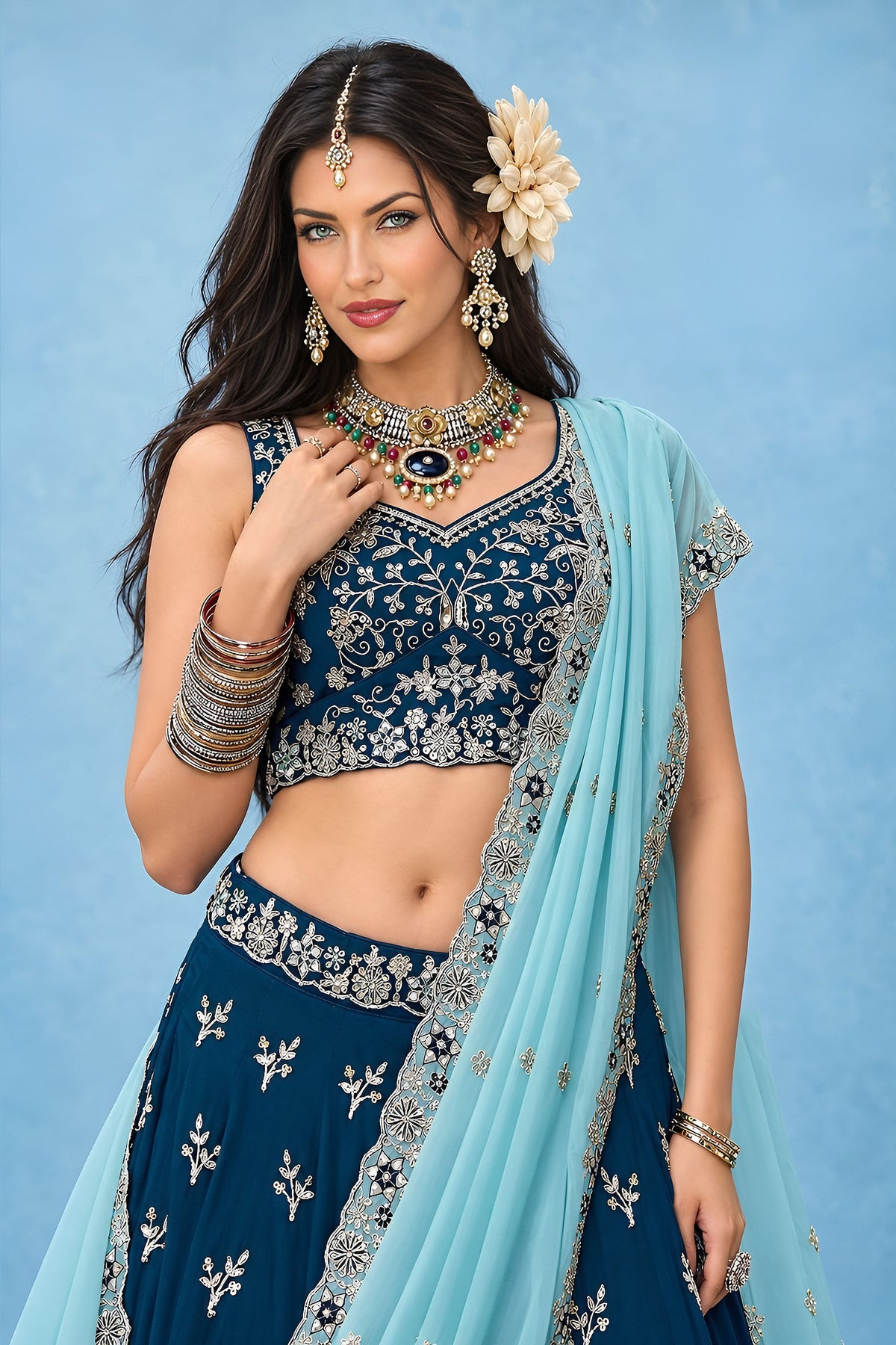 Half front view of a navy blue lehengas for wedding guest outfit, highlighting the sweetheart neckline and the detailed work on the blouse.