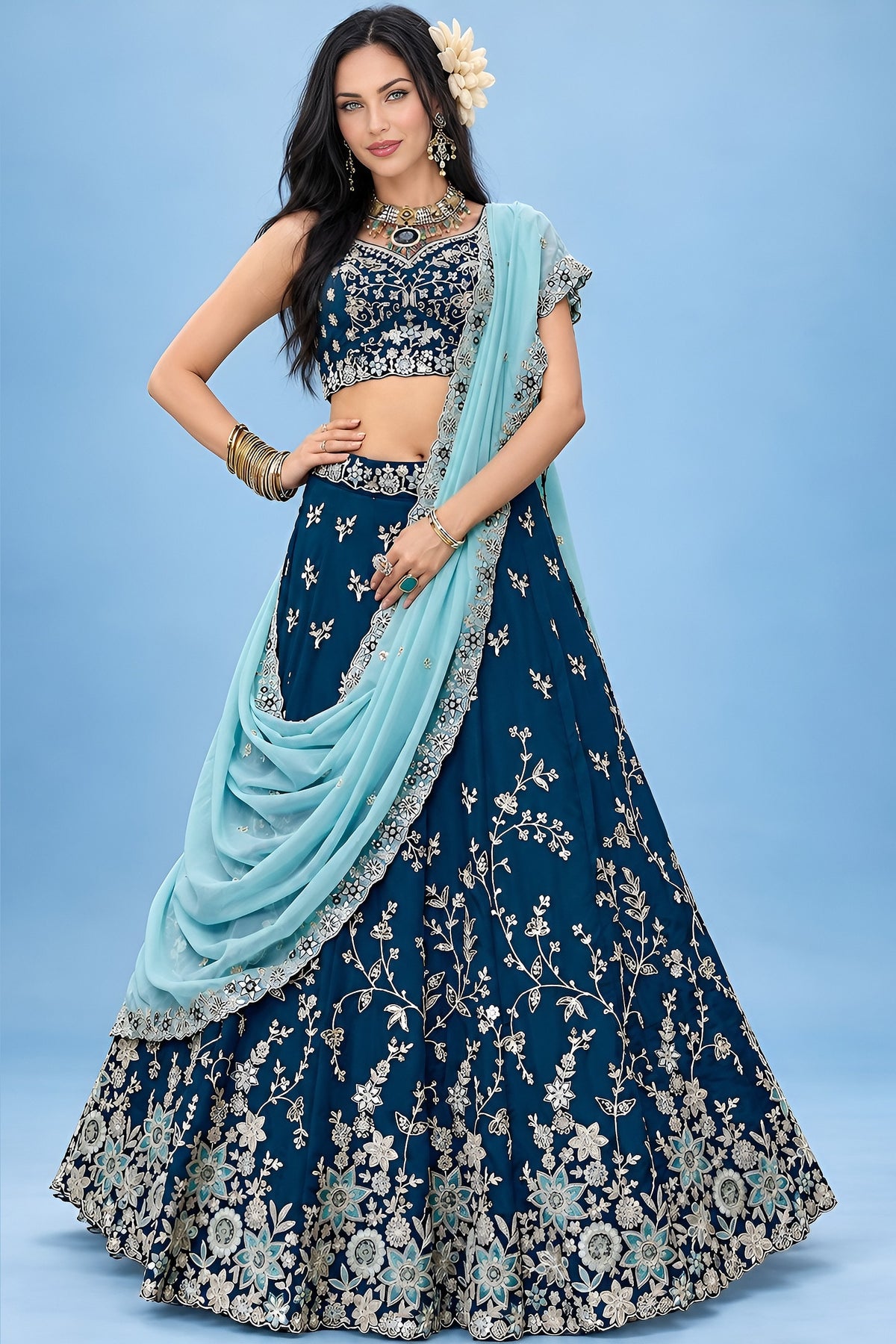 Front view of a navy blue lehengas for wedding guest ensemble with a sweetheart neckline blouse and zari, sequin and thread work on the skirt.