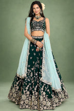A dark green lehenga for mehendi in rangoli silk, shown from the front with a flared skirt and a light mint dupatta over one shoulder.