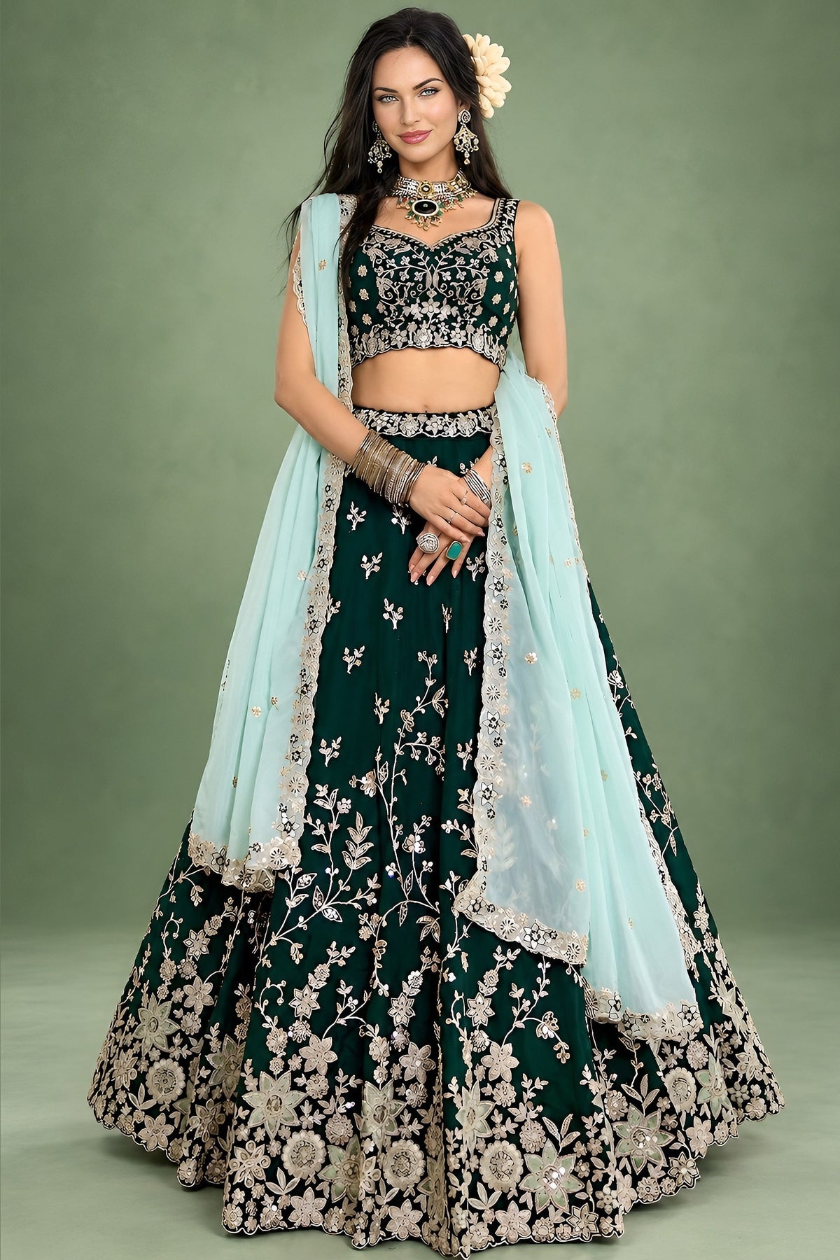 A dark green lehenga for mehendi in rangoli silk, shown from the front with a flared skirt and a light mint dupatta over one shoulder.