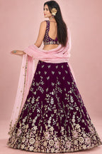 Back view of a maroon lehenga for marriage reception, showing the deep back neckline and the work carried on the back of the blouse and skirt.