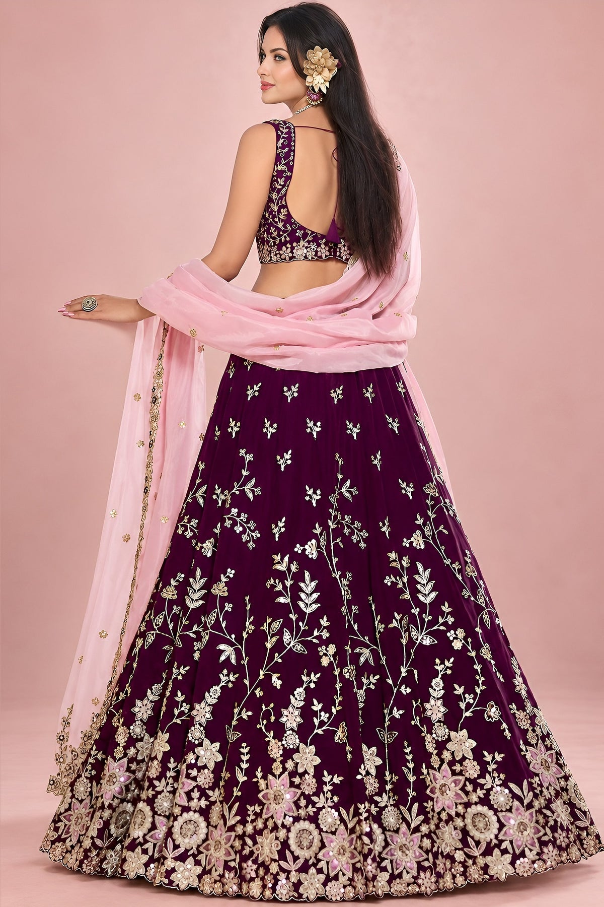 Back view of a maroon lehenga for marriage reception, showing the deep back neckline and the work carried on the back of the blouse and skirt.