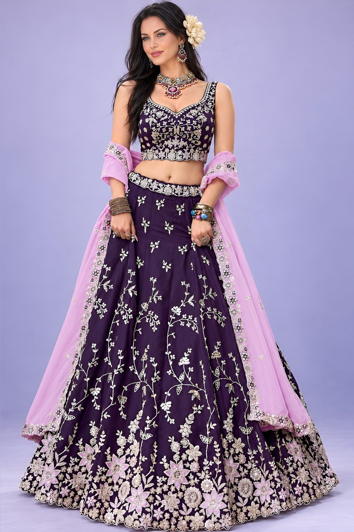 A dark purple lehenga for sangeet with a sleeveless sweetheart blouse, flared rangoli silk skirt and lavender dupatta, shown in a full front view.