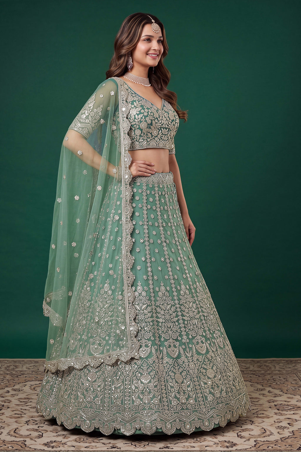 Alternate view of a pista sangeet lehenga in net with detailed zari, dori and sequins work on the sleeveless blouse and lehenga.