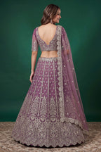 Full-length back view of a light purple sangeet lehenga in net with an open back blouse with dori tie and zari and sequins work.