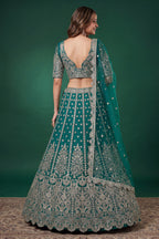 Alternate view of a teal sangeet lehenga in net with zari, dori and sequins work throughout on the sleeveless blouse and lehenga.