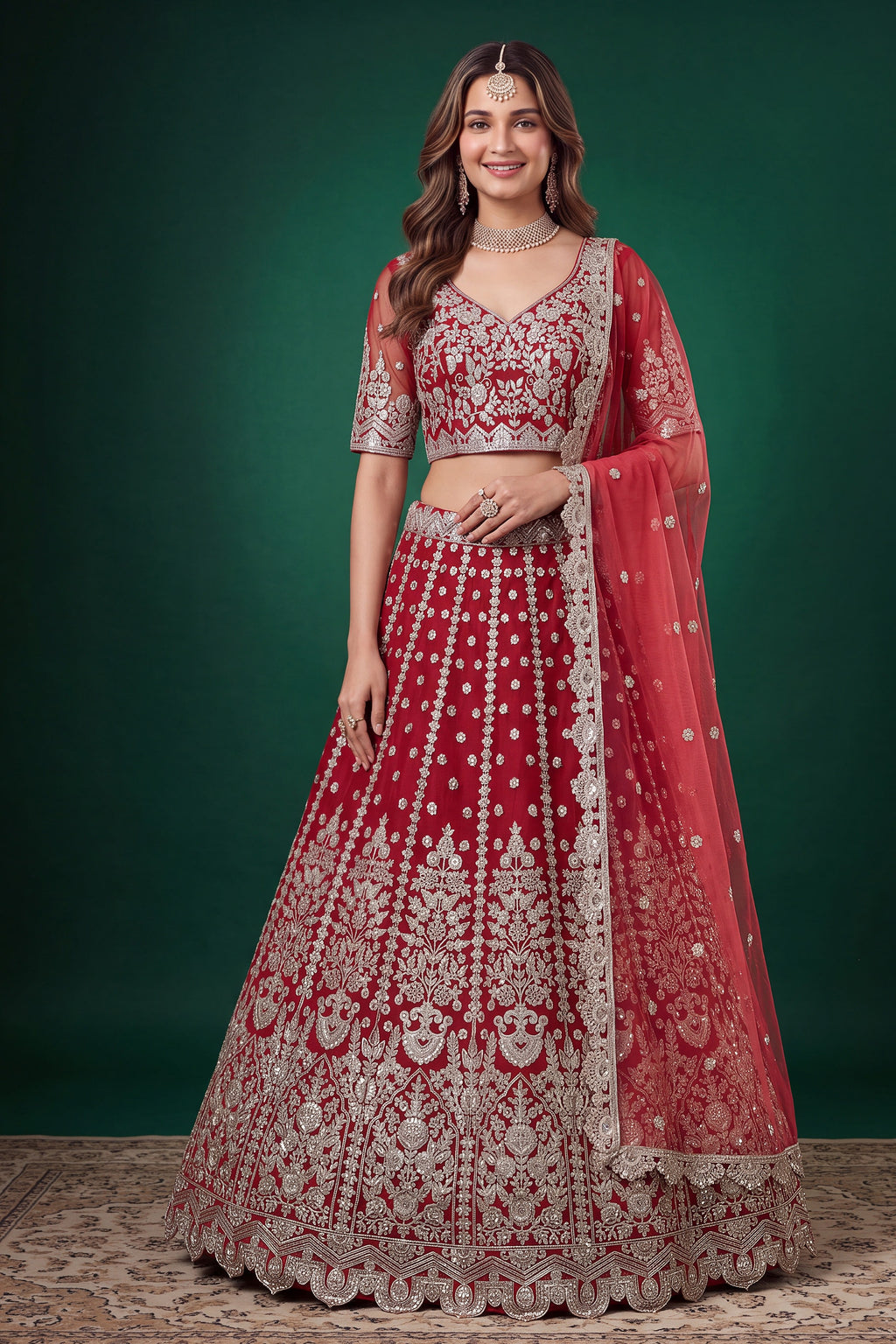 Woman wearing a red lehenga for wedding in net with zari, dori and sequins work, sleeveless sweetheart blouse, full-length front view.