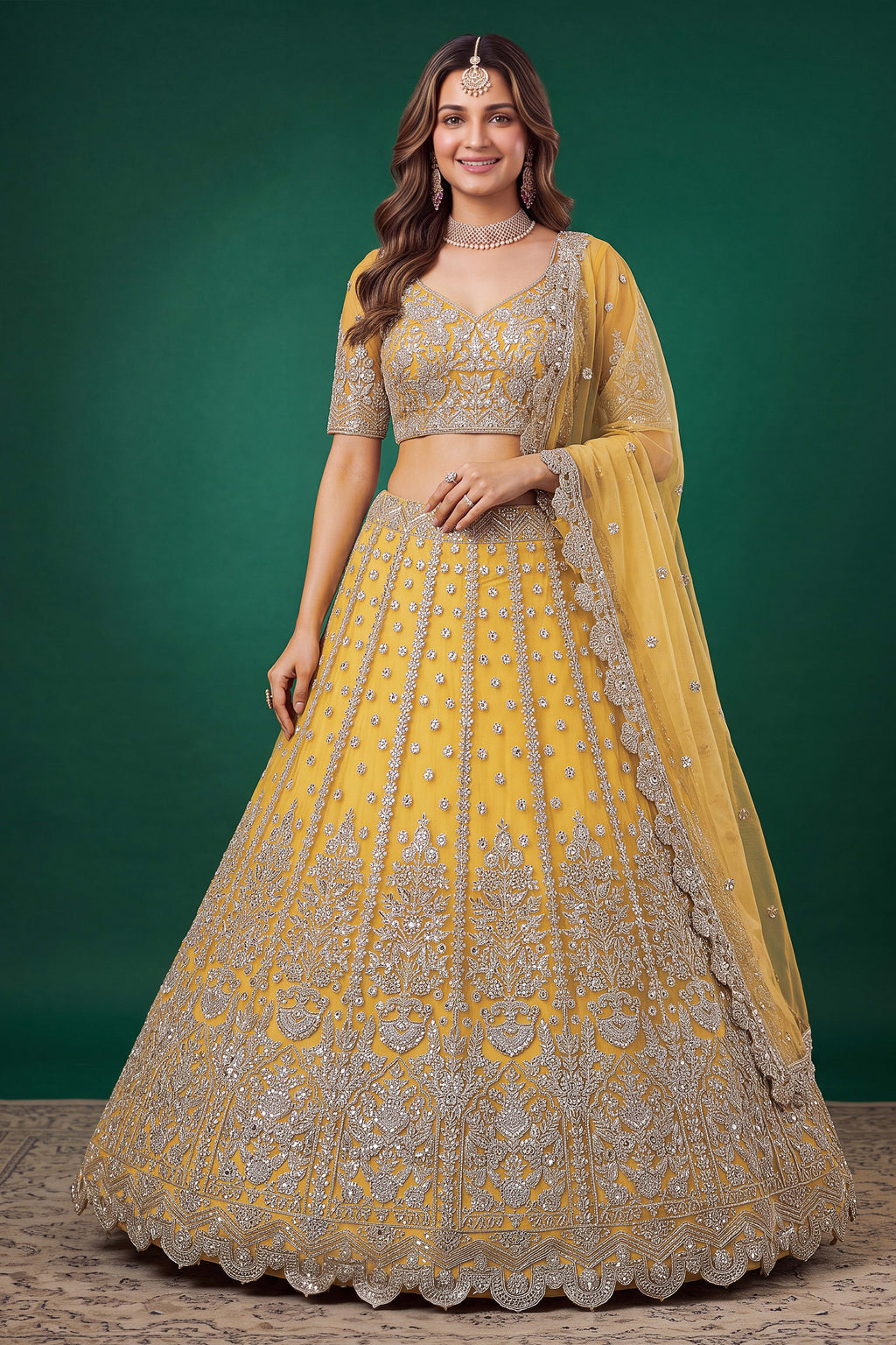 Woman wearing a mustard yellow haldi outfits lehenga in net with zari, dori and sequins work, sleeveless blouse, full-length front view.