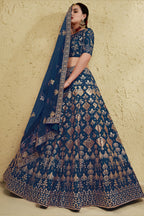 Full-length side view of a blue reception lehenga in art silk with zari and sequin embroidery work on the flared lehenga skirt.