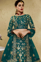 Close-up view of a green mehndi outfits lehenga in art silk with detailed zari and sequin embroidery work on the blouse and lehenga skirt.