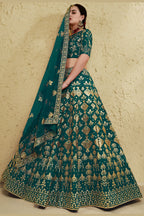 Full-length side view of a green engagement dresses for women lehenga in art silk with zari and sequin embroidery work on the flared skirt.
