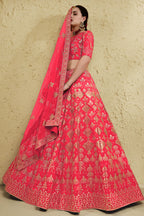 Full-length side view of a pinkish red engagement dresses for women lehenga in art silk with zari and sequin embroidery work on the flared skirt.