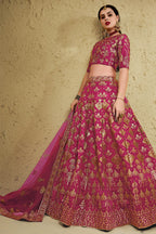 Alternate full-length view of a dark pink party wear lehenga in art silk with zari and sequin embroidery work on the blouse and lehenga.