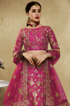Close-up view of a dark pink reception lehenga in art silk with detailed zari and sequin embroidery work on the blouse and lehenga skirt.