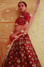 Alternate full-length view of a red lehenga for wedding in art silk with zari and sequin embroidery work on the blouse and lehenga.