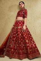 Full-length side view of a red engagement dresses for women lehenga in art silk with zari and sequin embroidery work on the flared skirt.