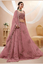 Full-length side view of a rust pink reception lehenga in georgette with zari, dori and sequin work on the flared lehenga skirt.