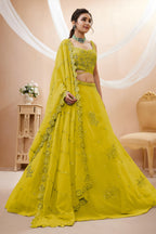 Full-length side view of a bright yellow reception lehenga in georgette with zari, dori and sequin work on the flared lehenga skirt.