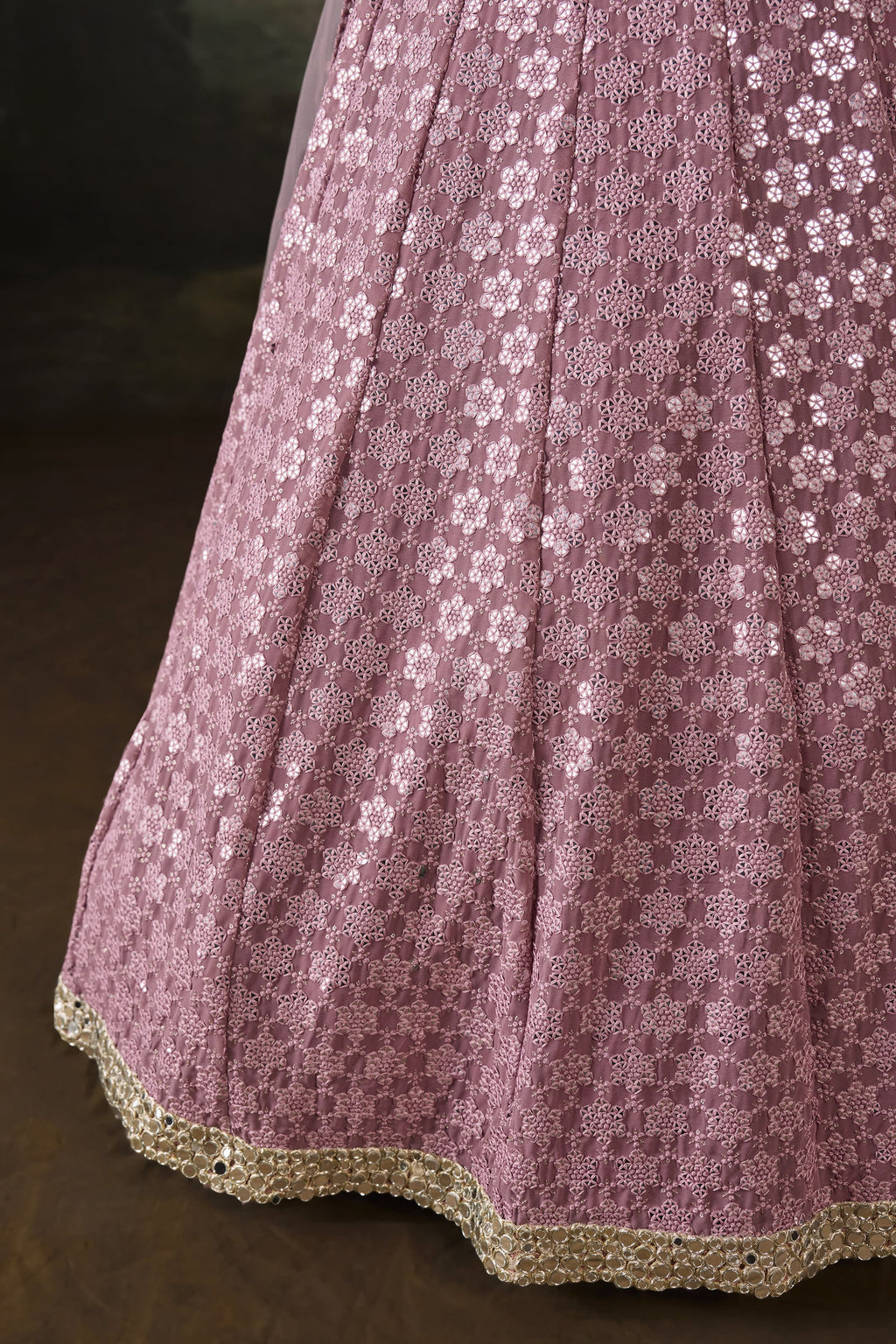 Close-up of the baby pink sangeet attire skirt with dense sequin and mirror work on georgette and the sheer net dupatta edge.