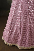 Close-up of the baby pink sangeet attire skirt with dense sequin and mirror work on georgette and the sheer net dupatta edge.